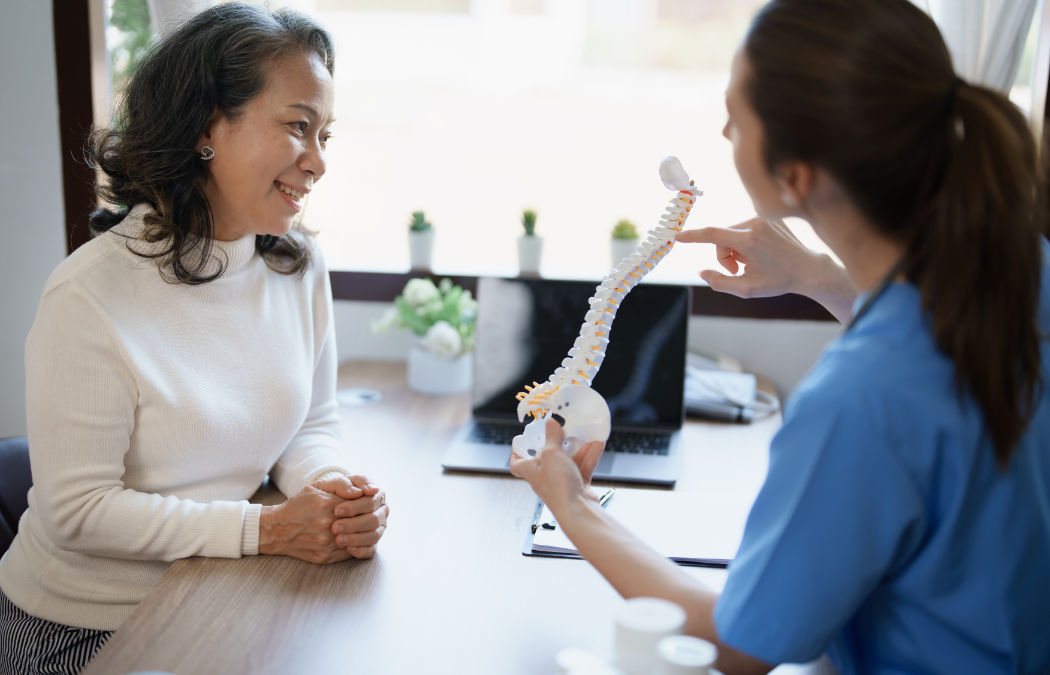 Female doctor talking to an elderly patient.