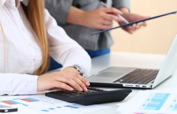 girl working at a laptop and calculator