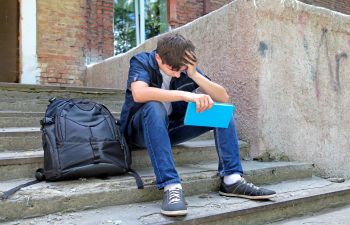 sad student sitting on the stairs