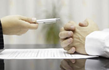 giving a pen to sign documents